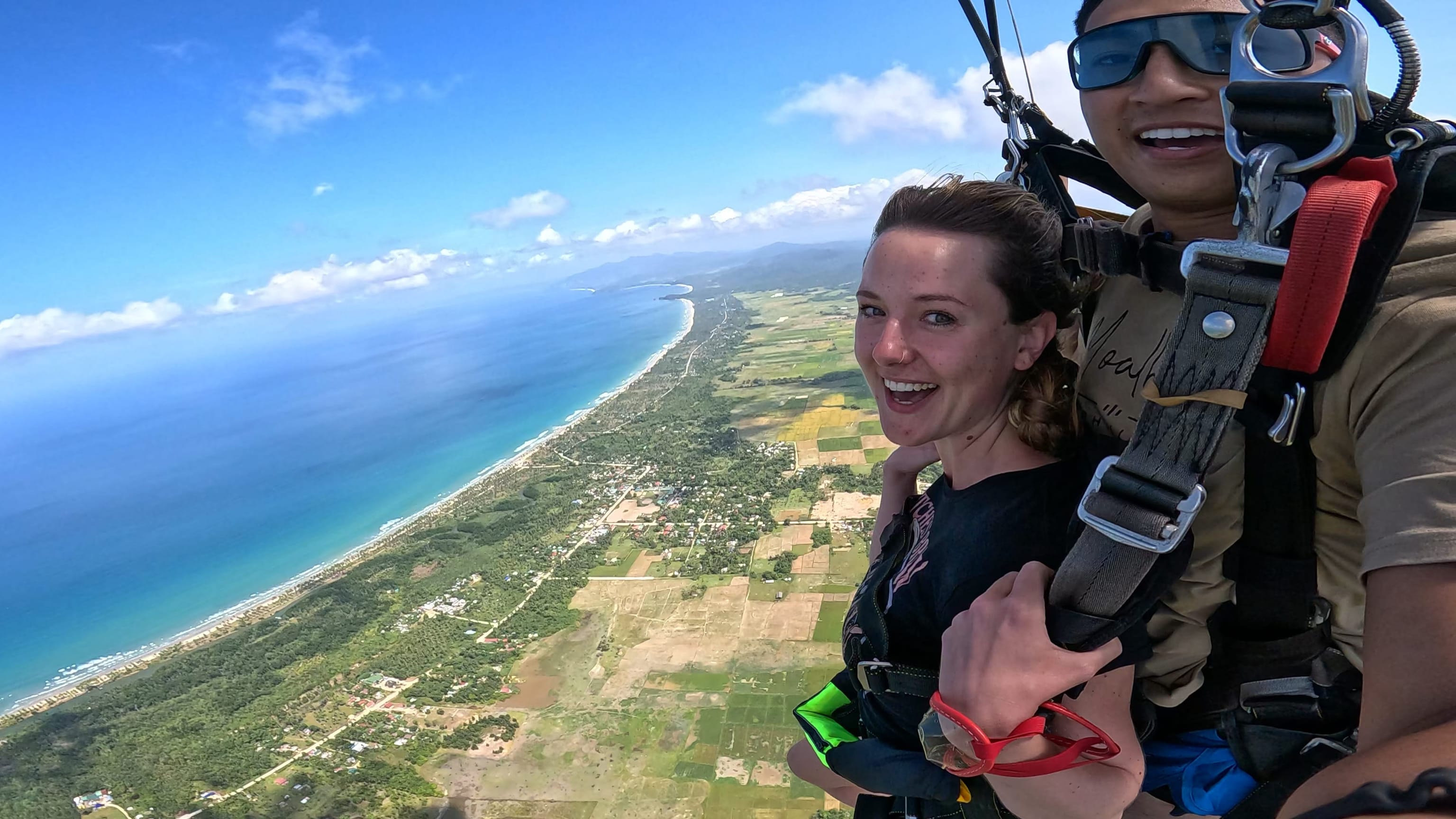 Tandem skydiver under canopy above Long Beach, San Vicente, Palawan