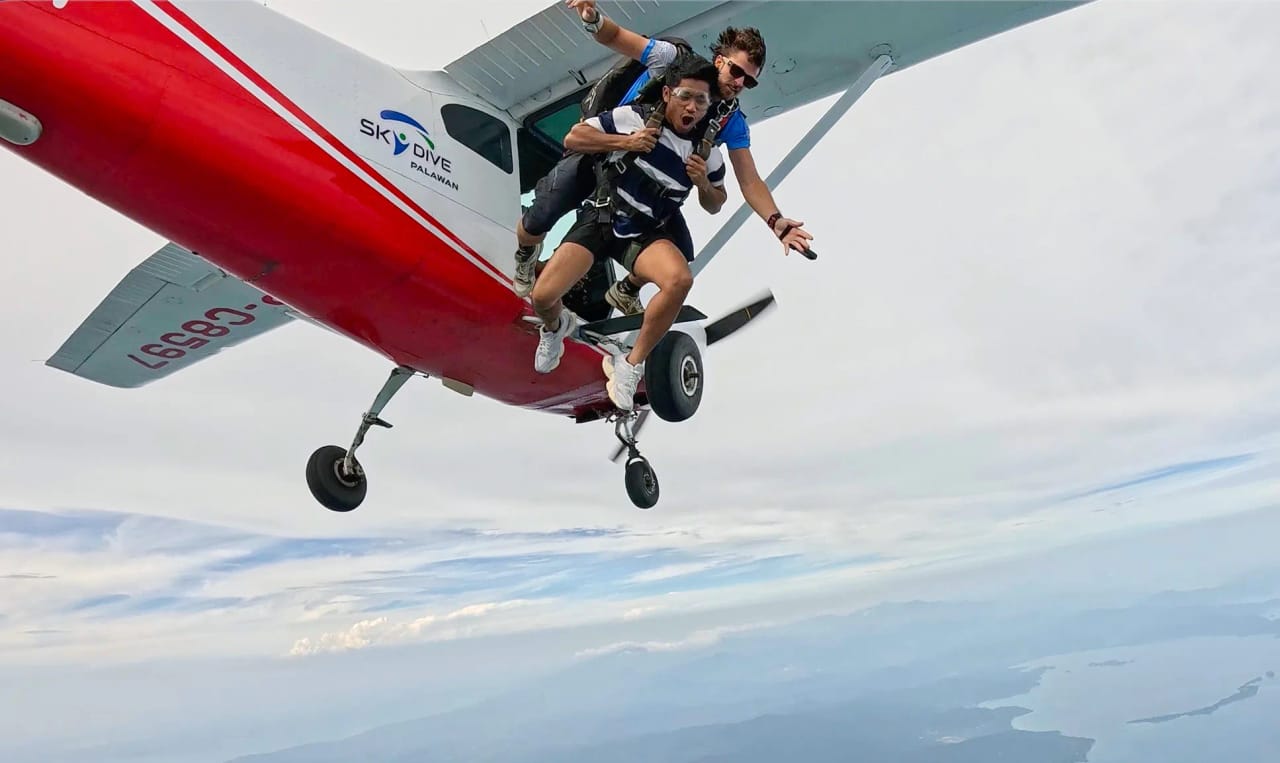 Tandem skydiver and instructor in freefall right after exiting the plane over Palawan