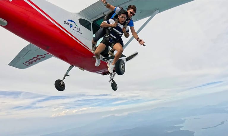 Tandem skydiver and instructor in freefall right after exiting the plane over Palawan